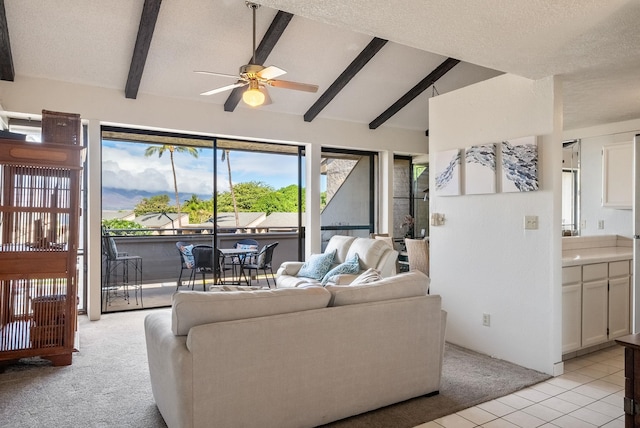 living room featuring ceiling fan, light colored carpet, lofted ceiling with beams, and a textured ceiling