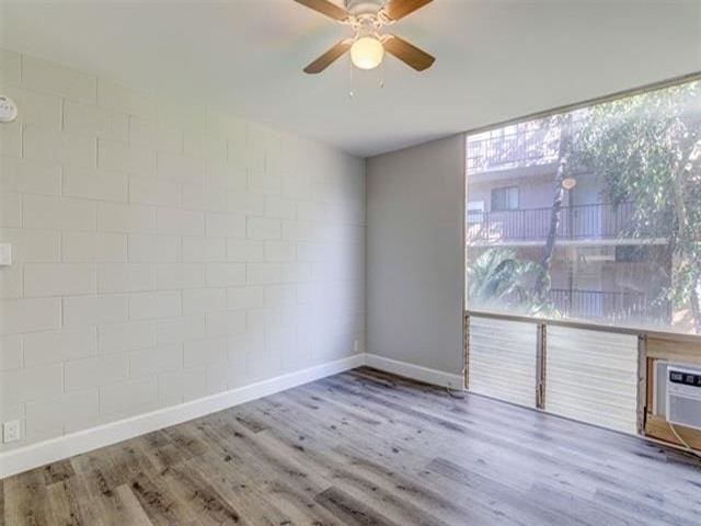 3676 Lower Honoapiilani Rd Unit F303, Lahaina, HI 96761 - unfurnished room featuring hardwood / wood-style floors, plenty of natural light, and ceiling fan