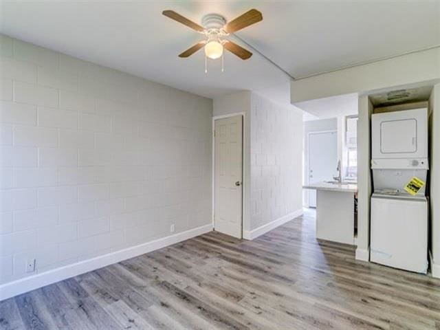 3676 Lower Honoapiilani Rd Unit F303, Lahaina, HI 96761 - interior space featuring stacked washer / drying machine, ceiling fan, and light wood-type flooring