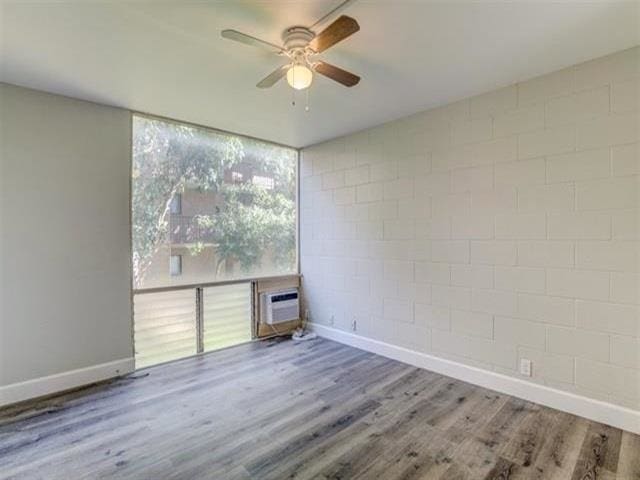 3676 Lower Honoapiilani Rd Unit F303, Lahaina, HI 96761 - unfurnished room with a wall unit AC, ceiling fan, and hardwood / wood-style floors