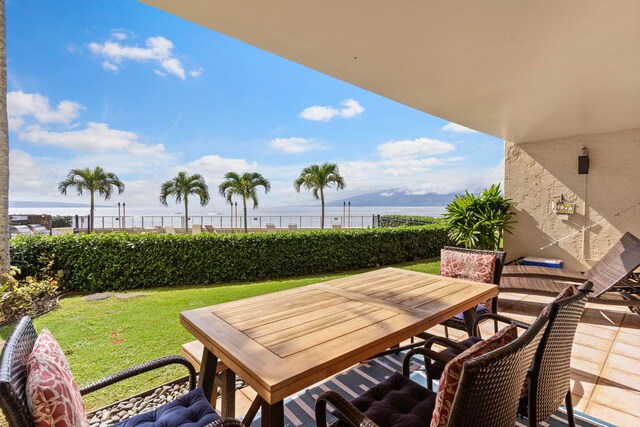 balcony featuring a water view and a patio area