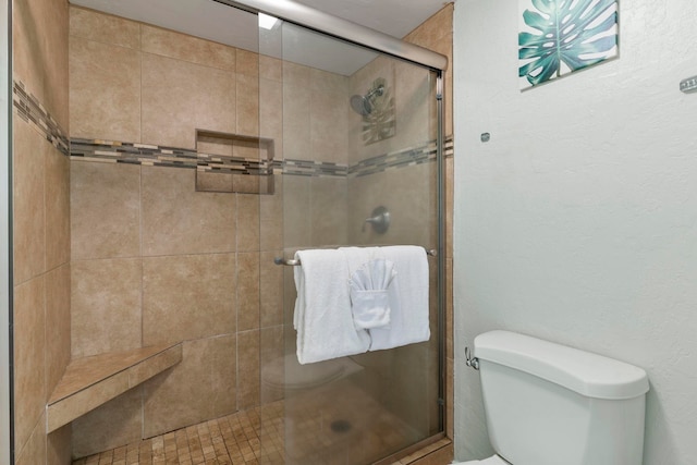 bathroom with an enclosed shower and toilet