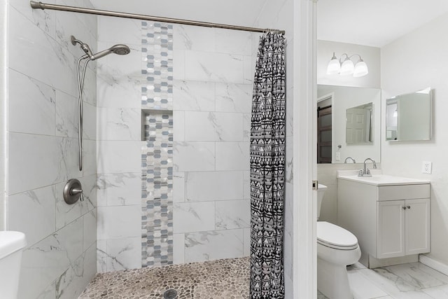 full bath featuring tiled shower, toilet, marble finish floor, and vanity