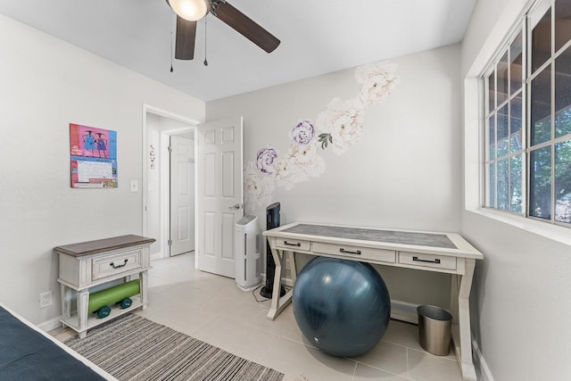 misc room with light tile patterned flooring, baseboards, and ceiling fan