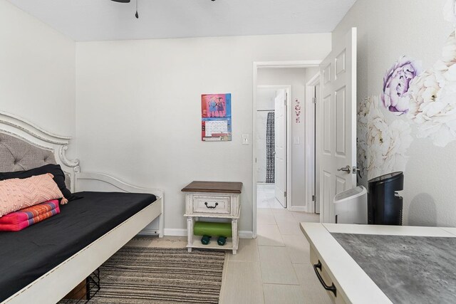 tiled bedroom featuring baseboards