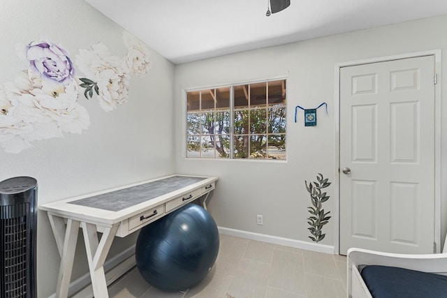 clothes washing area with baseboards