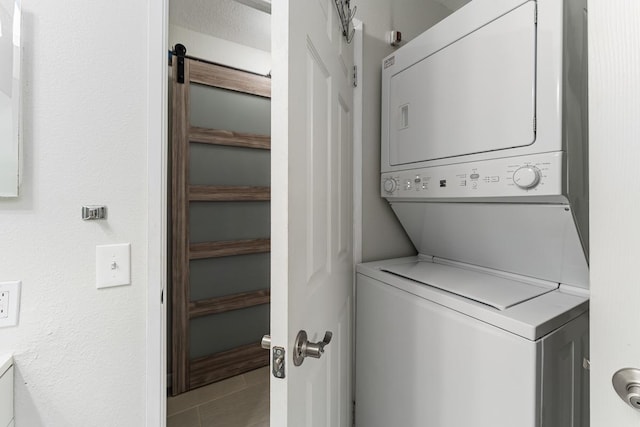 laundry area with stacked washer / dryer and laundry area