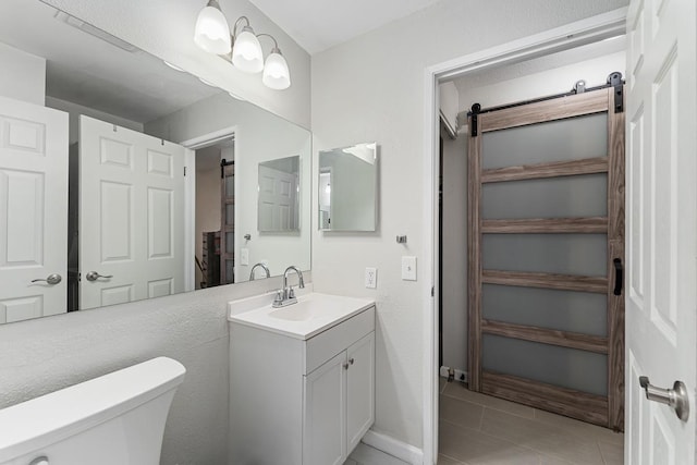 bathroom featuring tile patterned floors, toilet, and vanity