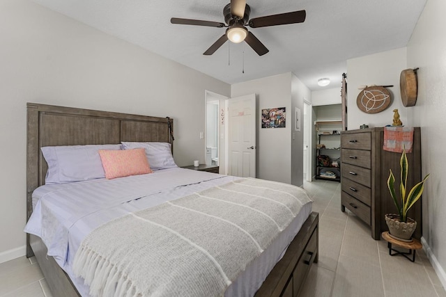 bedroom with light tile patterned floors, baseboards, and ceiling fan