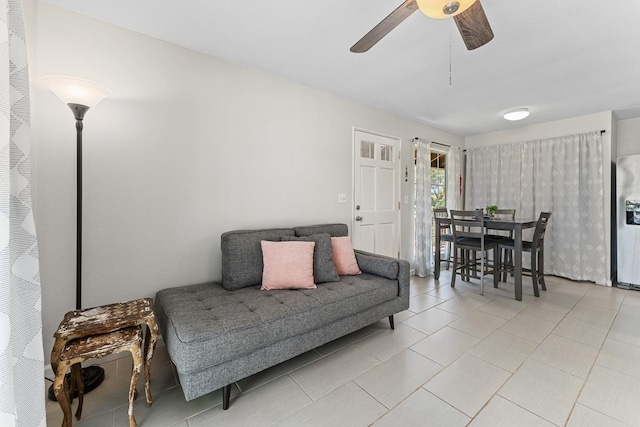 living area featuring light tile patterned floors and a ceiling fan