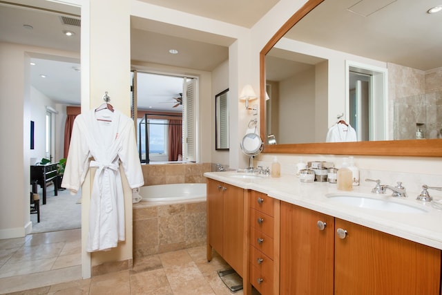 bathroom with tiled bath, tile patterned flooring, vanity, and ceiling fan