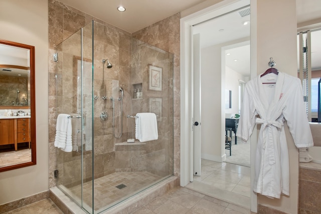 bathroom featuring vanity, an enclosed shower, and tile patterned flooring