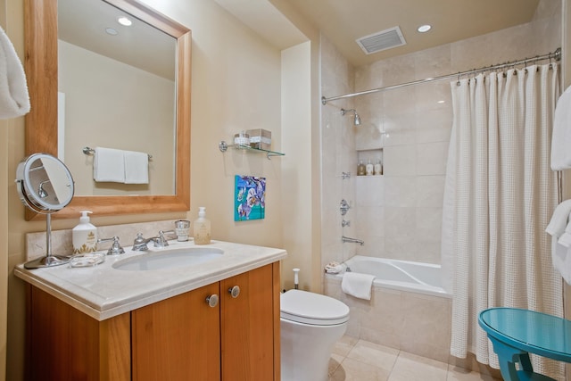 full bathroom featuring tile patterned flooring, vanity, shower / bath combo with shower curtain, and toilet