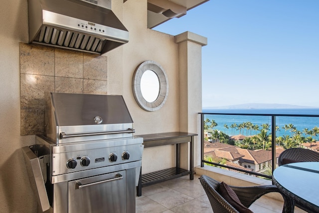 view of patio with a water and mountain view, area for grilling, and a balcony