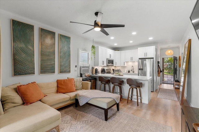 4435 Lower Honoapiilani Rd Unit 142, Lahaina, HI 96761 - living room featuring a ceiling fan, recessed lighting, light wood-type flooring, ornamental molding, and cooling unit
