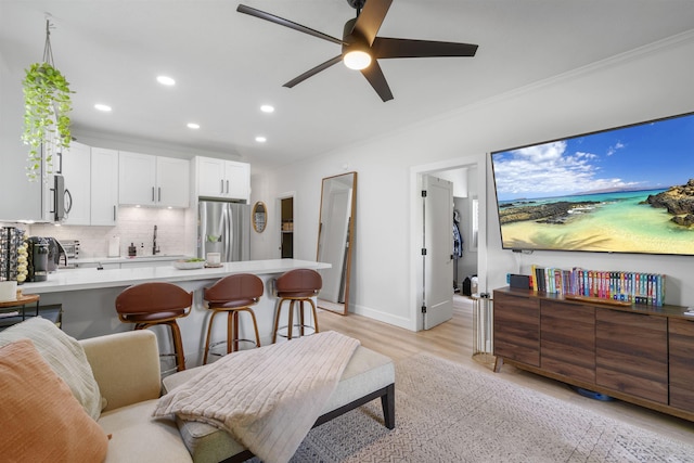 4435 Lower Honoapiilani Rd Unit 142, Lahaina, HI 96761 - living room with recessed lighting, ceiling fan, light wood-type flooring, ornamental molding, and baseboards