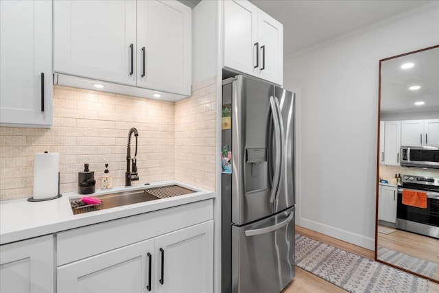 4435 Lower Honoapiilani Rd Unit 142, Lahaina, HI 96761 - kitchen with appliances with stainless steel finishes, a sink, backsplash, light countertops, and white cabinetry