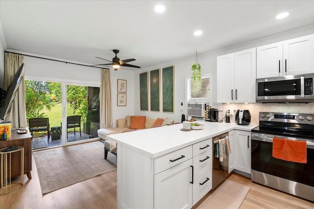 4435 Lower Honoapiilani Rd Unit 142, Lahaina, HI 96761 - kitchen with appliances with stainless steel finishes, decorative backsplash, light wood-style flooring, a peninsula, and recessed lighting