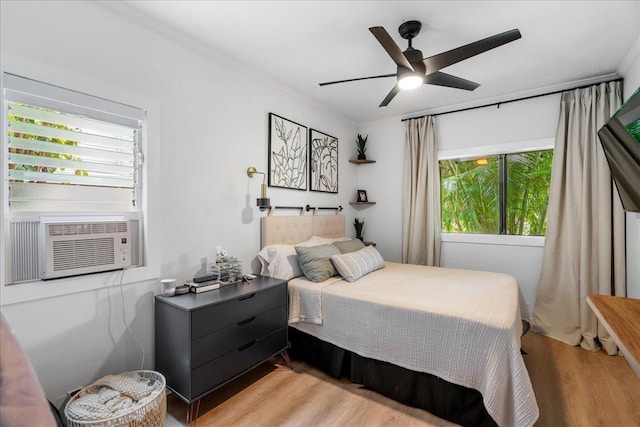 4435 Lower Honoapiilani Rd Unit 142, Lahaina, HI 96761 - bedroom featuring crown molding, light wood-type flooring, cooling unit, and a ceiling fan