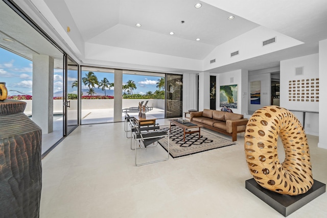 living area featuring recessed lighting, a raised ceiling, and vaulted ceiling