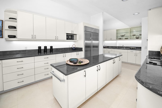 kitchen with open shelves, stainless steel appliances, a sink, a kitchen island, and recessed lighting