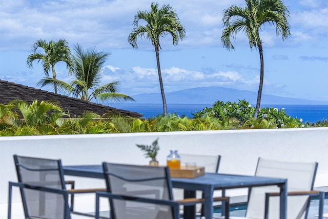 view of patio / terrace with a water and mountain view