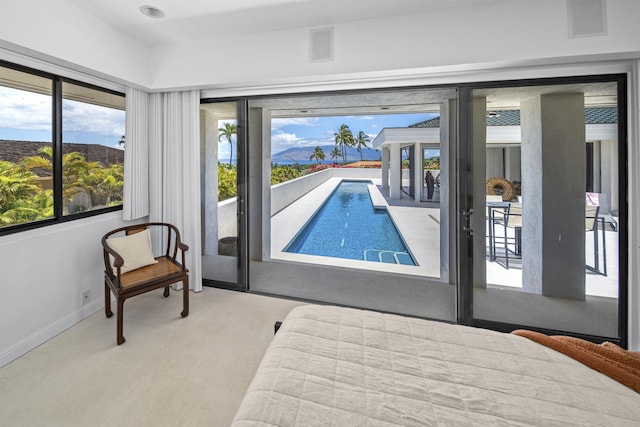 bedroom featuring baseboards and access to outside