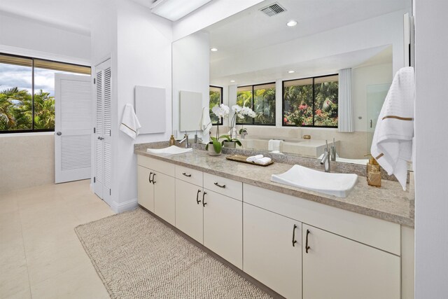 bathroom with double vanity and recessed lighting