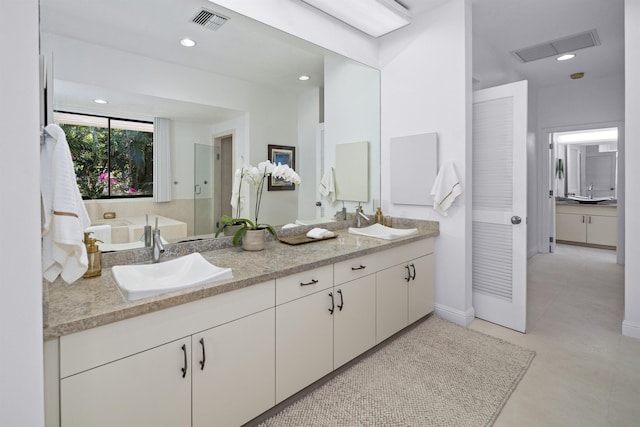 bathroom with double vanity, recessed lighting, baseboards, and an enclosed shower