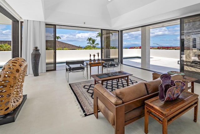 sunroom / solarium featuring finished concrete flooring and vaulted ceiling