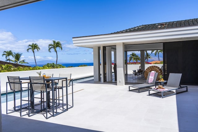 view of patio / terrace featuring a water view and outdoor dining space