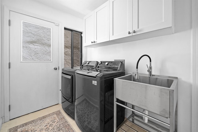 washroom with washer and dryer and cabinet space