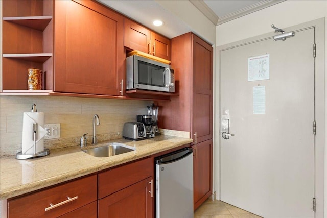 kitchen with decorative backsplash, appliances with stainless steel finishes, light stone counters, ornamental molding, and sink