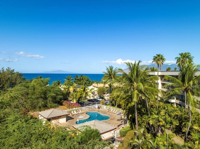 view of swimming pool with a patio area and a water view