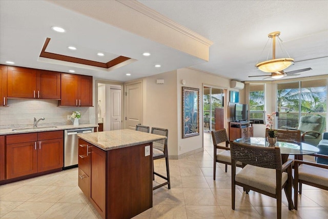 kitchen with backsplash, ceiling fan, decorative light fixtures, dishwasher, and a center island