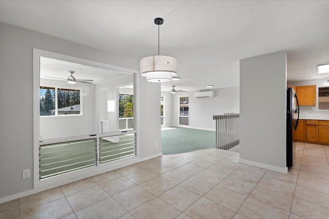 185 Hololani St, Pukalani, HI 96768 - spare room featuring a ceiling fan, a wall unit AC, light tile patterned floors, and baseboards