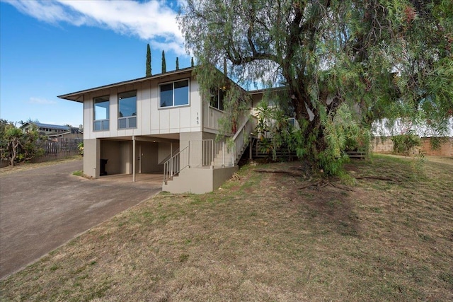 185 Hololani St, Pukalani, HI 96768 - rear view of house with a carport, concrete driveway, stairway, and board and batten siding