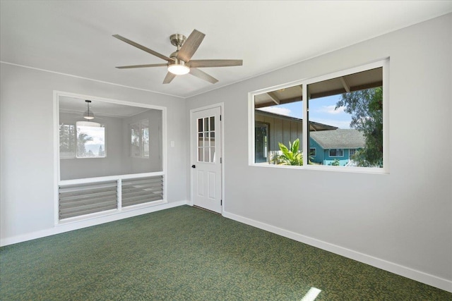 185 Hololani St, Pukalani, HI 96768 - spare room featuring baseboards, dark carpet, and a ceiling fan