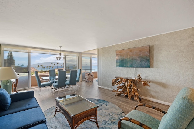 45 Kai Ala Dr Unit A615, Lahaina, HI 96761 - living area featuring plenty of natural light, wood finished floors, baseboards, and a wall of windows