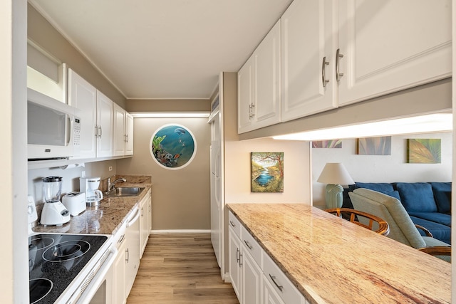 45 Kai Ala Dr Unit A615, Lahaina, HI 96761 - kitchen featuring white appliances, a sink, light wood-style floors, white cabinets, and baseboards