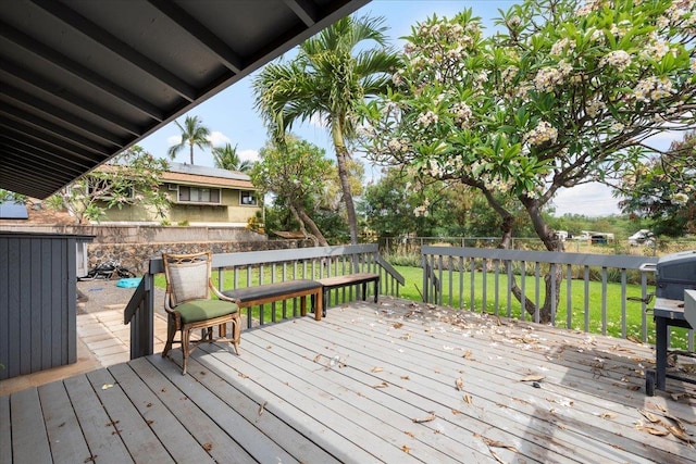 wooden terrace with a fenced backyard and a lawn