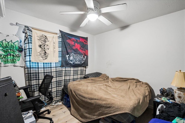 bedroom featuring a ceiling fan and wood finished floors