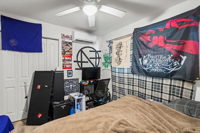 bedroom featuring a closet, ceiling fan, wood finished floors, and a wall mounted air conditioner