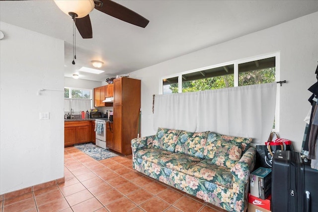 living room featuring a ceiling fan and light tile patterned flooring