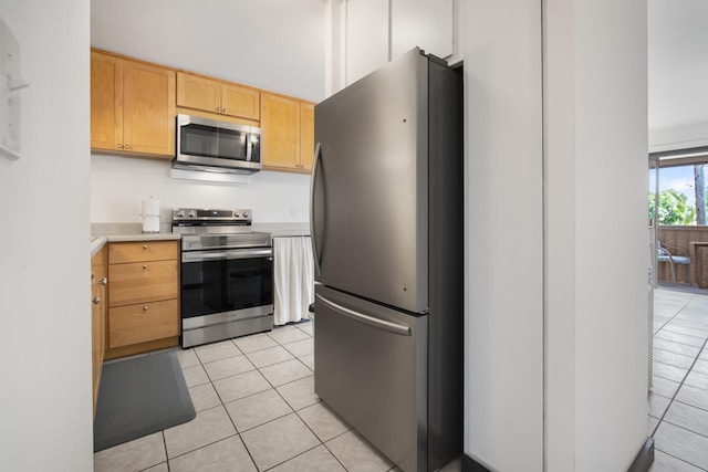7 Kaiau Pl Unit 6, Kihei, HI 96753 - kitchen with appliances with stainless steel finishes, light tile patterned floors, light countertops, and light brown cabinets