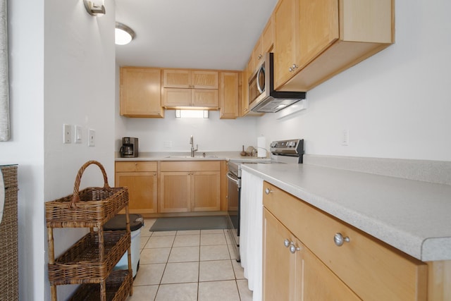 7 Kaiau Pl Unit 6, Kihei, HI 96753 - kitchen with stainless steel appliances, light brown cabinetry, light countertops, and light tile patterned flooring