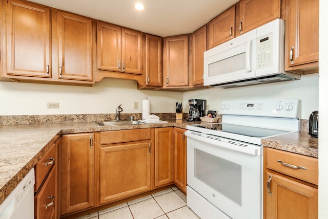 kitchen with white appliances and light tile patterned floors