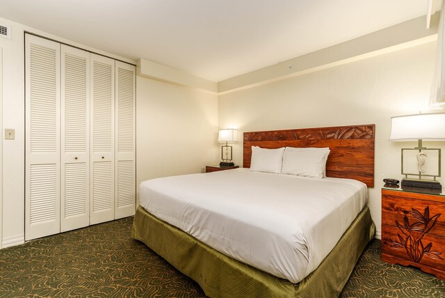 carpeted bedroom with a closet