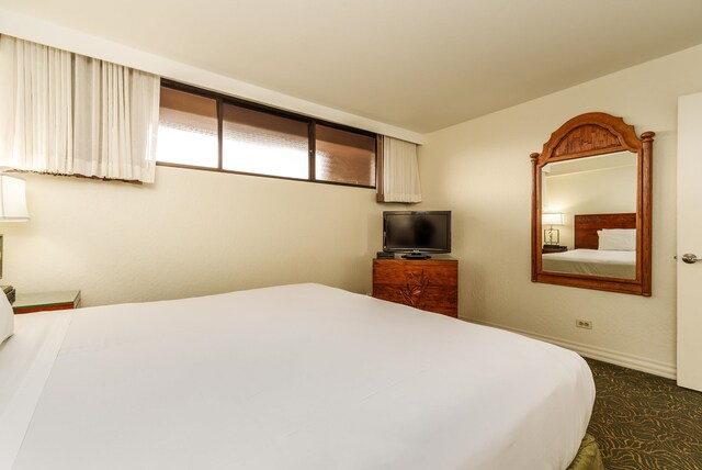 bedroom featuring dark colored carpet