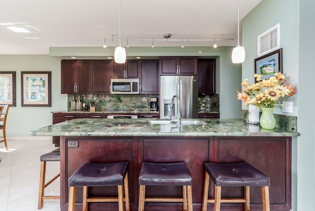 50 Nohea Kai Dr Unit 2-1106, Lahaina, HI 96761 - kitchen with appliances with stainless steel finishes, backsplash, decorative light fixtures, and light stone counters